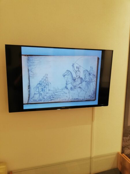ekran na nim rysunek żołnierz na koniu z szablą w dłoni